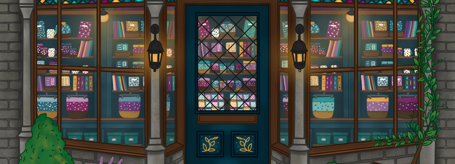 Decorative window display with books and colorful patterns on a building facade.