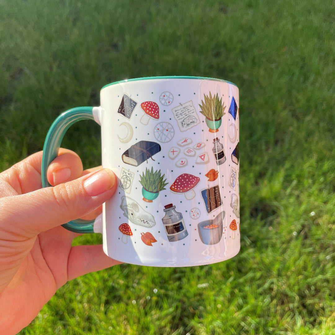 druid themed mug in green feature mushrooms, skulls, plants and runes in shades of greens and blues