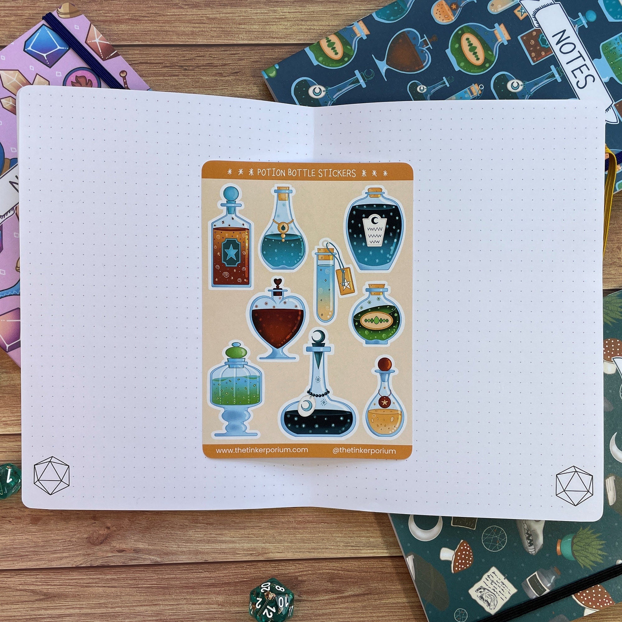 A6 Apothecary sticker set with 9 potion bottle paper stickers sat on an A5 notebook to show size